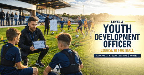 Youth Development Officer supporting young football players during a structured academy training session.